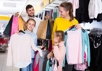 parents with two little girls during family shopping