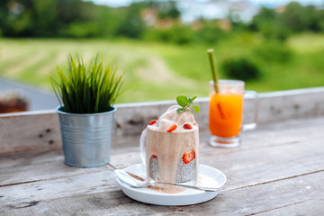 Food and drink, healthy eating and dieting concept. White chia pudding with fresh berries and carrot smoothies on table outdoor