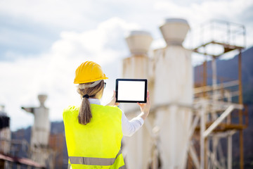 Female architect photographing with tablet
