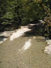 Mountain stream is washed by sharp rocks of the mountain