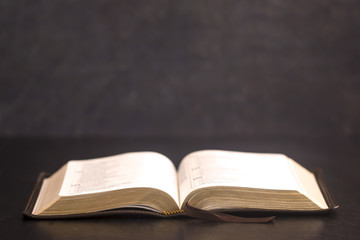 Open Bible on a Slate Tabletop with Customizable Space to Add Text