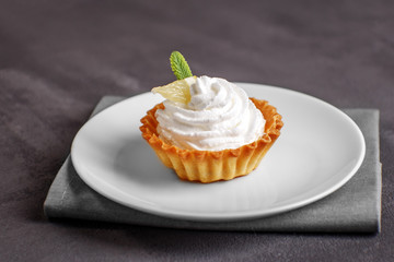 Sweet tasty cake with cream on the plate. The concept of food, desserts, restaurant.