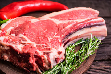 Raw beef steak with pepper and rosemary