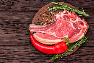 Raw beef steak with pepper and rosemary