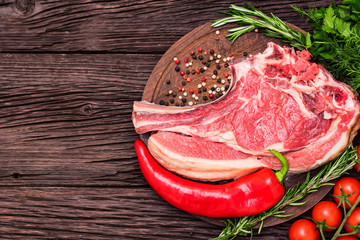 Raw beef steak with pepper, herbs and tomatoes