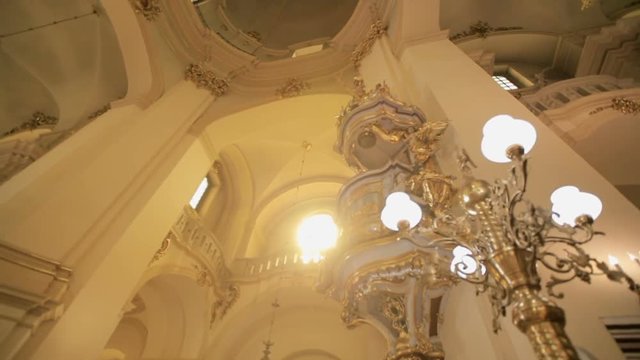 Beautiful interior of the Catholic Church with frescoes, mosaics, stucco, crystal