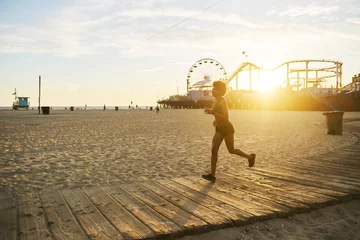 Papier Peint photo Jogging athletic african american woman jogging on boardwalk at sunset