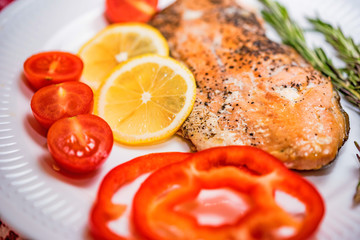 Salmon steak with vegetables close up