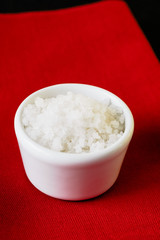 Tiny serving bowl filled with coarse sea salt, so called Fleur de Sel