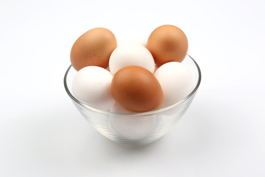 chicken eggs lie in plate on white background.