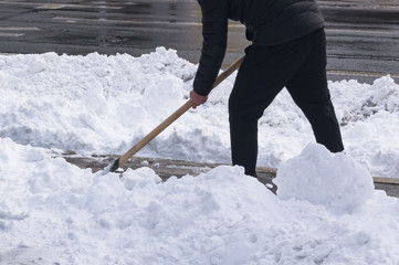 Naklejka premium Snow cleaning with a shovel after a snowstorm