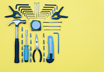 Set of tools. Home improvement concept on yellow background.