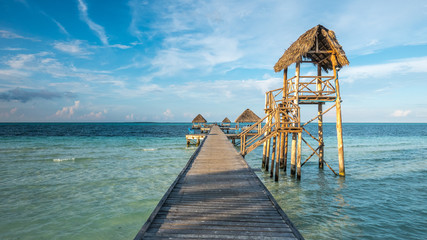 Beautiful wooden pier and bungalows built over the Caribbean Sea, at Cayo Guillermo and Playa...