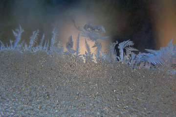 frosty patterns on the window glass closeup