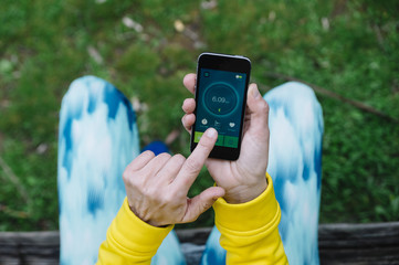 Woman using a running App in smartphone