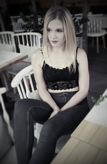 Fototapeta na wymiar A beautiful blond girl in cafe