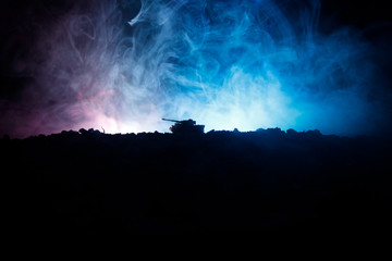 Fototapeta na wymiar War Concept. Military silhouettes fighting scene on war fog sky background, World War German Tanks Silhouettes Below Cloudy Skyline At night. Attack scene. Armored vehicles. Tanks battle. Close up