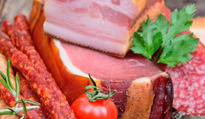 Bacon with sausages and salami and herbs