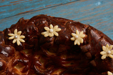 Karavai loaf cake on wooden rustic table background, top view. Traditional slavic russian and ukranian festivals and weddings bread, close-up