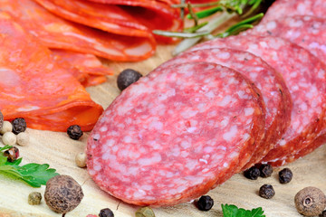 Sliced of salami and chorizo with herbs