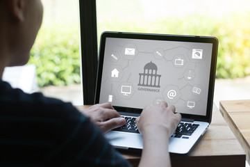 GOVERNANCE and building, Authority Computing Computer Laptop with screen on table Silhouette and filter sun