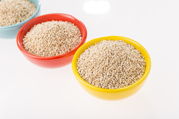 Quinoa grains in bowl isolated on white background, Chenopodium quinoa