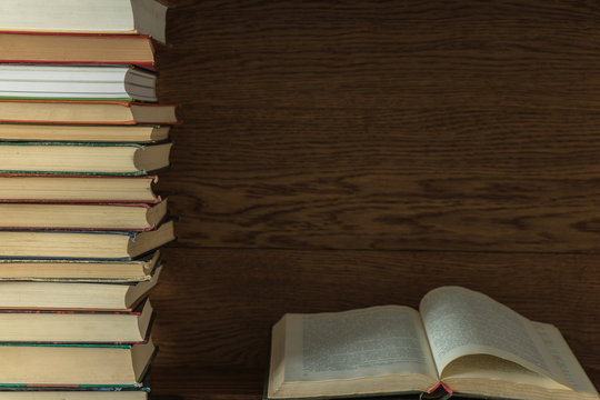 old books on a wooden shelf. stacked one on the other. background. open book.