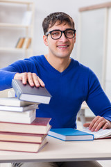 Male student preparing for exams in college library