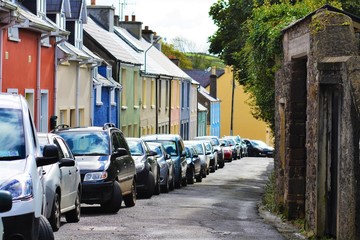 Colorful houses with cars parked on side