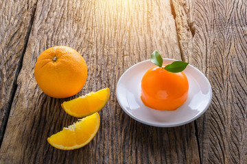 Orange cake on grunge wooden table
