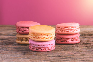 Different types color of macaroons on Old grunge wooden background