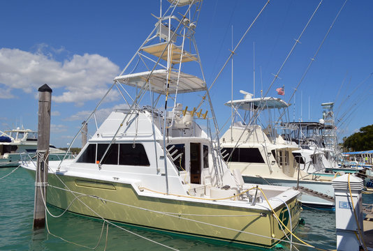 Charter deep sea fishing boats moored at a marina on Haulover Beach inlet in southeast florida