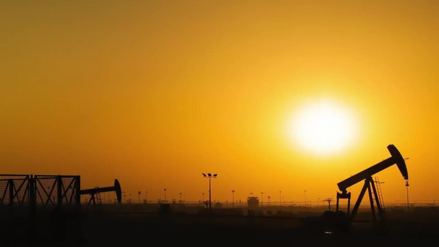 Oil Pumps Timelapse at Sunset. Pan