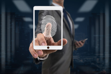 Businessman Fingerprint scan the smart table for unlock th screenover blurred data center server room with cityscape background, Business Technology sceurity Concept.