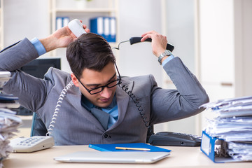 Desperate sad employee  tired at his desk in call center