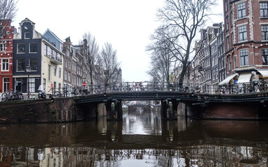 Naklejka na ściany i meble Dec 20, 2017 - Bridge over Amsterdam canal on a misty winter day