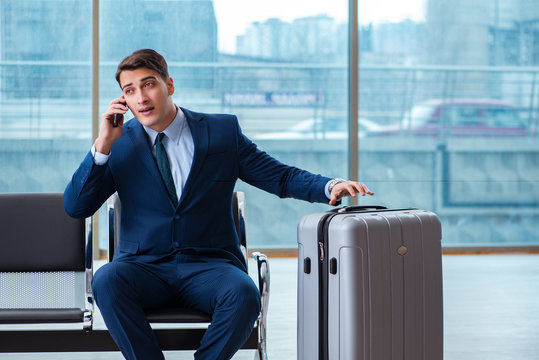 Businessman waiting at the airport for his plane in business cla