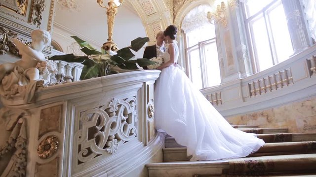 Wedding couple indoors is hugging each other