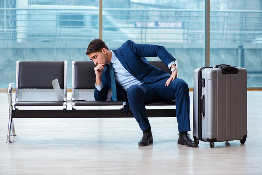 Businessman waiting at the airport for his plane in business cla