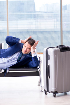 Businessman waiting at the airport for his plane in business cla