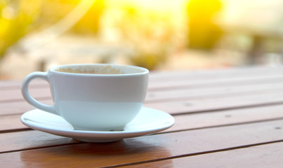 white cups with hot espresso on wood table and nature light