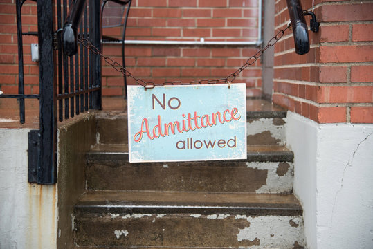 no admittance allowed sign hanging on chain in city