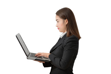 young business woman, standing wearing a white shirt and black suit holding a laptop pc.