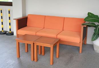 Orange fabric sofa with mini table.
