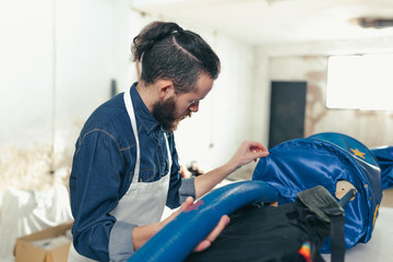 Man craftsman working in a craft workshop making a carnival costume