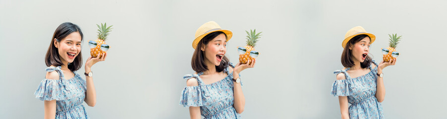 Young girl happy smile and cheerful in blue dress, hold two pineapple in hand. Concept summer travel.