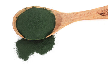 Spirulina algae powder in wooden spoon isolated on white background. Top view