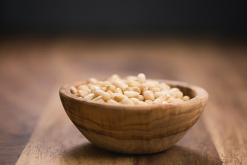 pine nuts in wood bowl on table