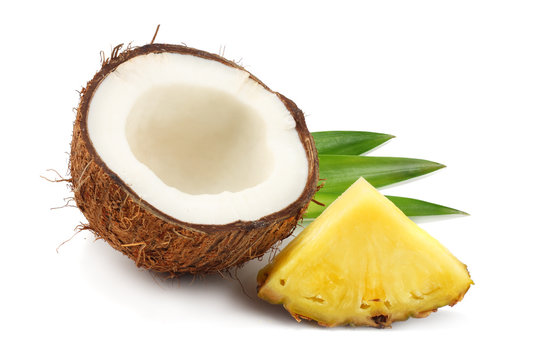 Coconut with pineapple and green leaves isolated on white background