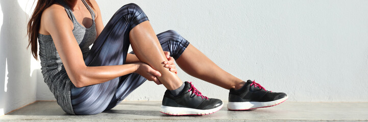 Running sport injury leg pain - runner woman runner hurting holding painful sprained ankle muscle....
